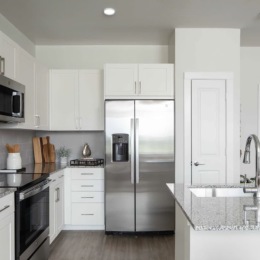 kitchen with ample counter-space, modern appliances and bright lighting