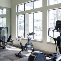 fitness center with open spaces and bright lighting through the windows